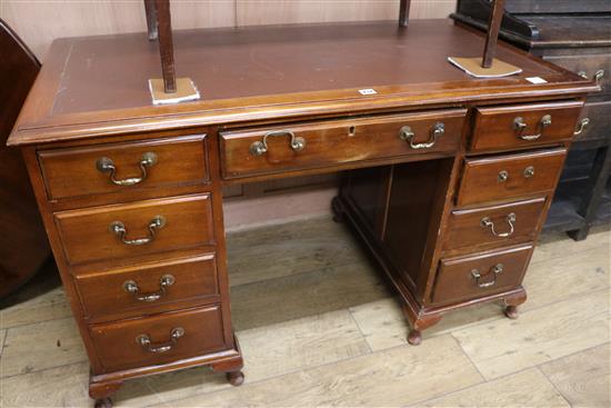 A mahogany kneehole pedestal desk, fitted nine small drawers, W.126cm